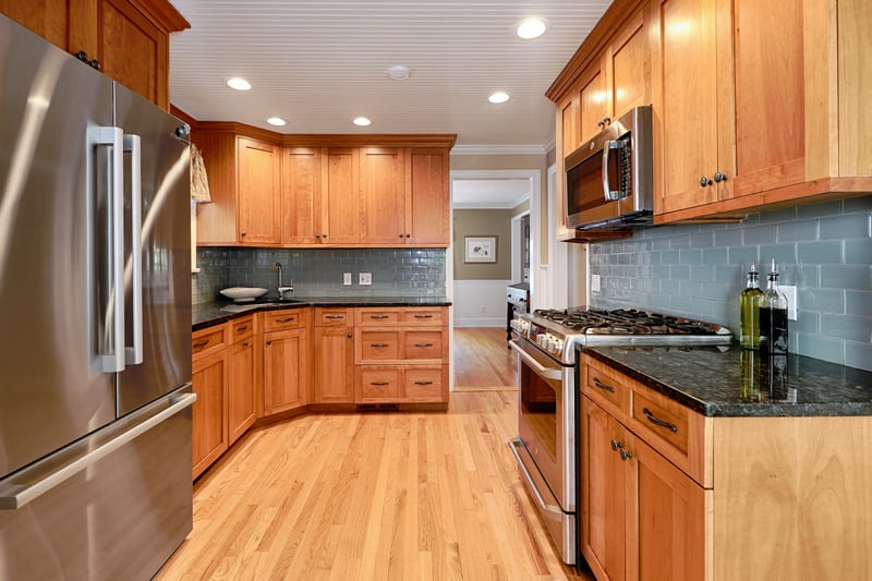 Kitchen features gas stove, new stainless refrigerator, microwave and granite counters.