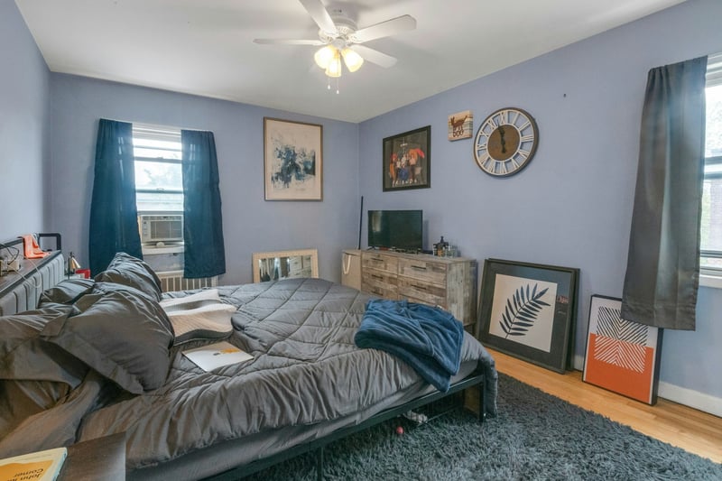 Bedroom with a ceiling fan, cooling unit, and wood finished floors