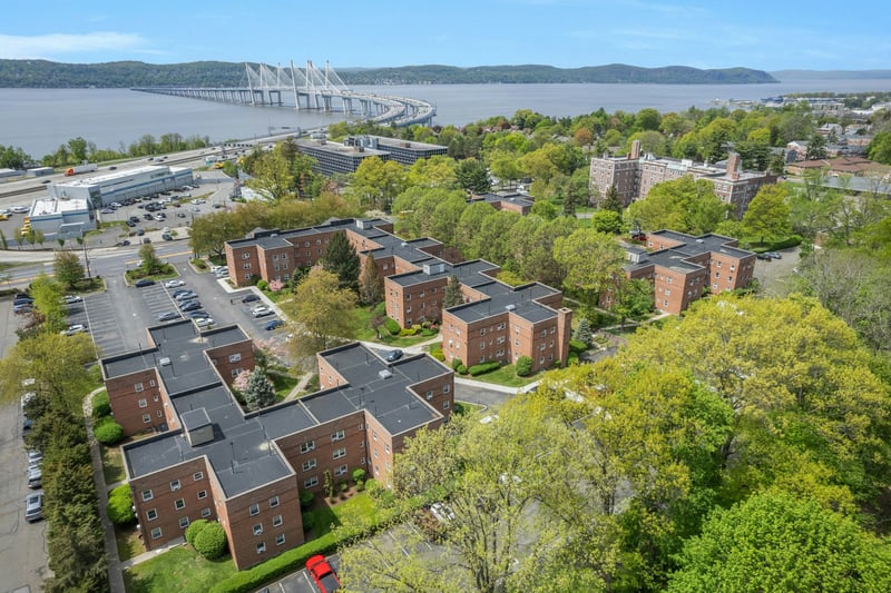 Birds eye view of property with a water and mountain view