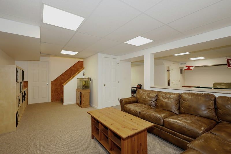 Finished Lower Level featuring wall to wall carpeting, work out room, wine cellar, and kitchen. Convenient access to both interior of the home and the three car attached garage.