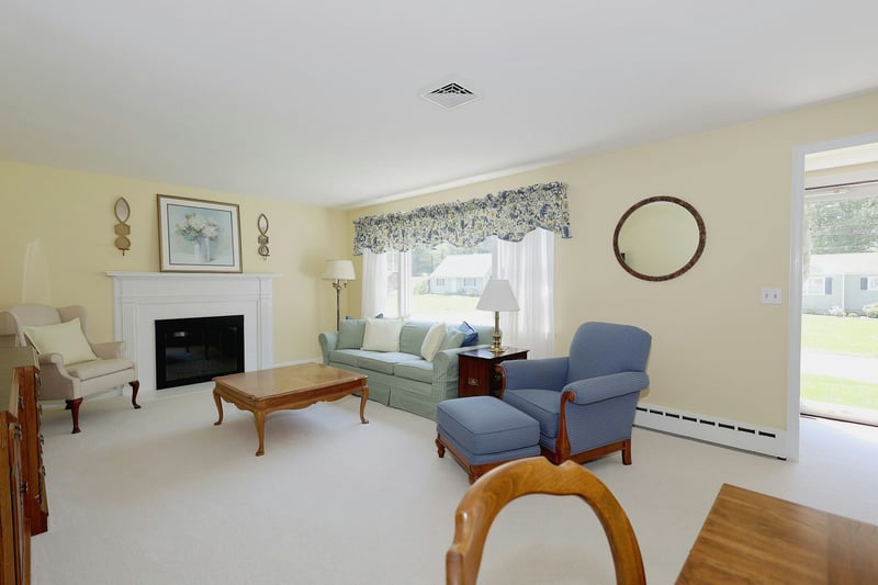 Large picture window and a wood burning fireplace.