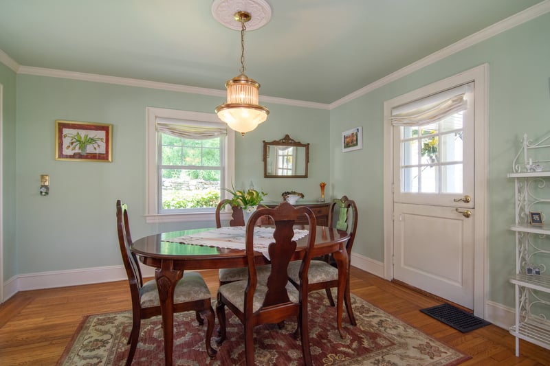 A charming Dutch door provides easy access to a private covered porch....