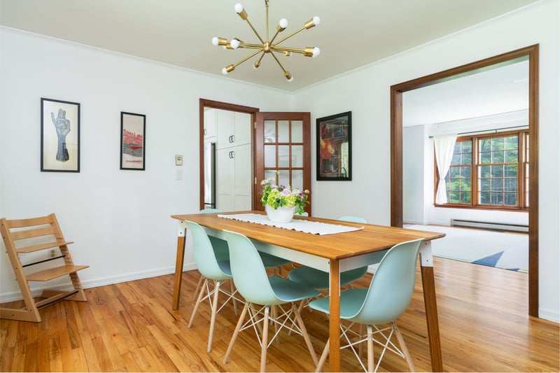 Dining area featuring a chandelier, light wood-type flooring, baseboard heating, and baseboards