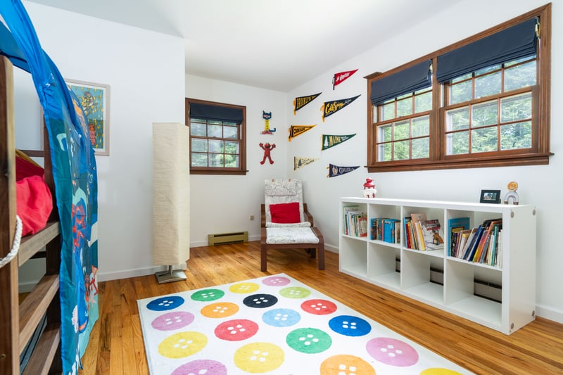 Bedroom featuring a baseboard heating unit, wood finished floors, and baseboards