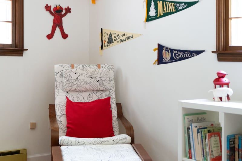Sitting room with baseboard heating, wood finished floors, and baseboards