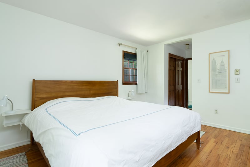 Bedroom with wood finished floors and baseboards