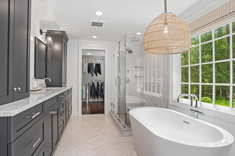 Rich navy custom cabinets and designer lighting
