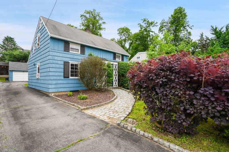 View of home's exterior with a paver pathway to the front entrance