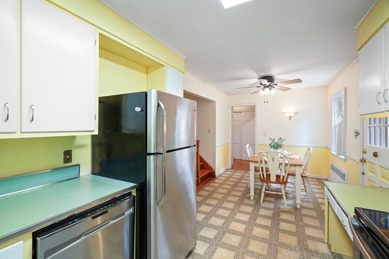 Kitchen featuring appliances with stainless steel finishes, light countertops, ceiling fan