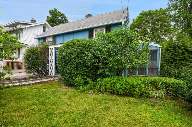 View of front of house featuring a front yard and a chimney
