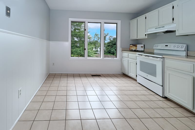 Spacious sun filled eat-in kitchen with woodland views.