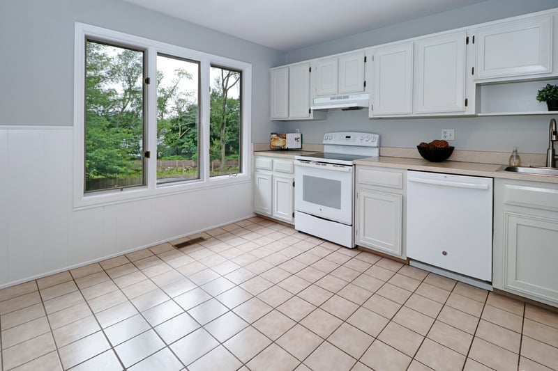 The kitchen, with tile floor, provides ample storage.