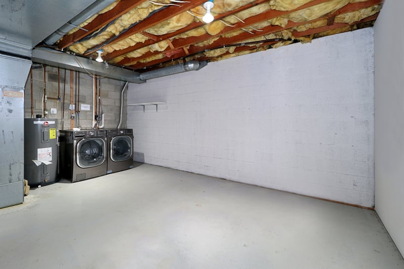 Unfinished basement with laundry area.