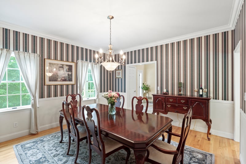 Formal Dining room featuring a chandelier, wallpapered walls, plenty of natural light, light wood-style flooring, and ornamental molding