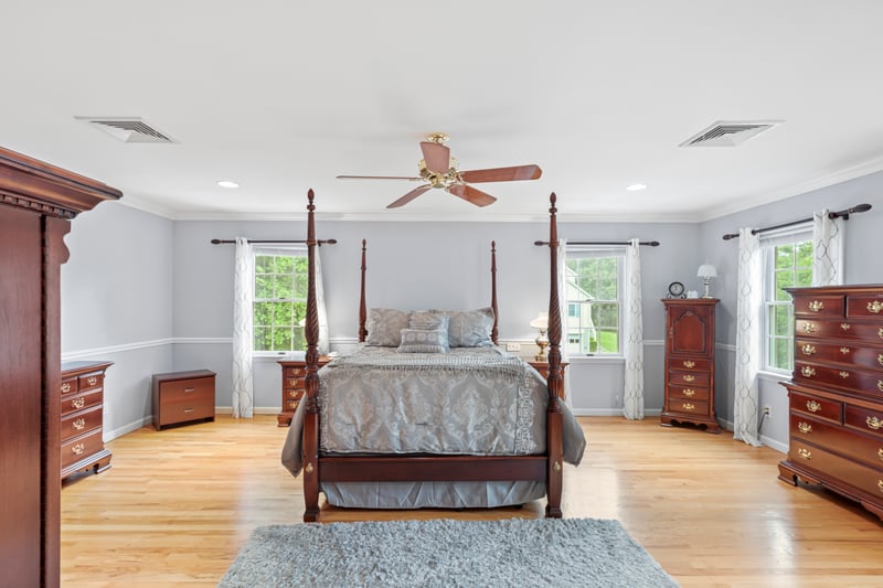 Primary suite featuring crown molding, light wood-style floors, recessed lighting, and a ceiling fan