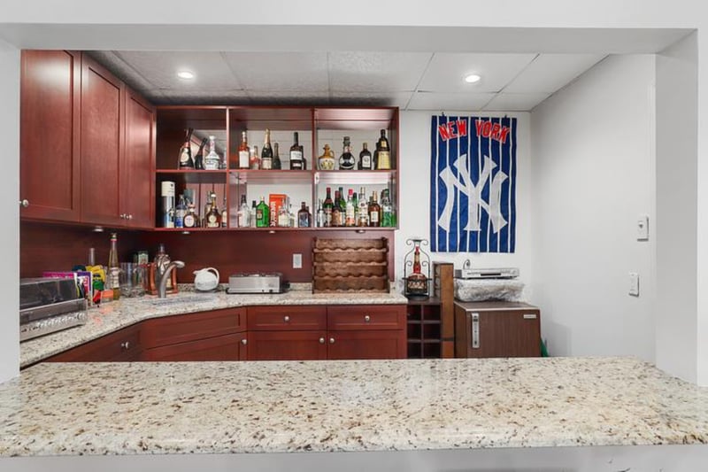 Indoor wet bar with a drop ceiling and recessed lighting
