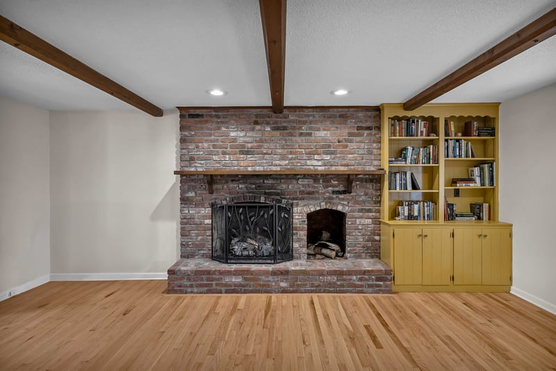 Featuring a gas fireplace and built-in cabinetry.