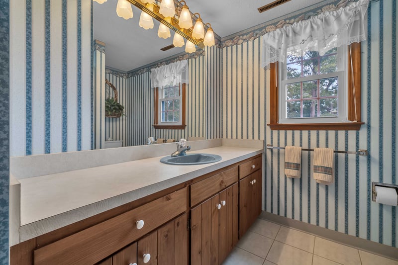 This second full bathroom features a tub with shower.