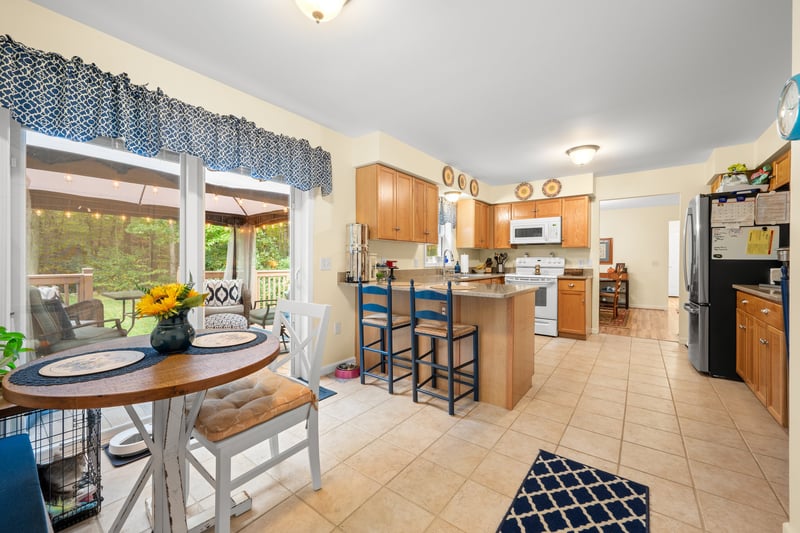 Spacious kitchen with slider leading to deck