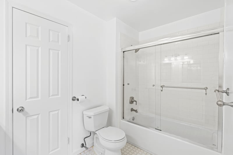 Full Hall bathroom featuring combined bath / shower with glass door and tile patterned flooring