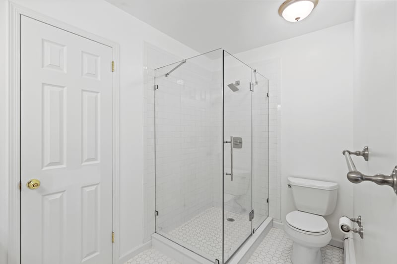 Full bath with a stall shower and tile patterned floors