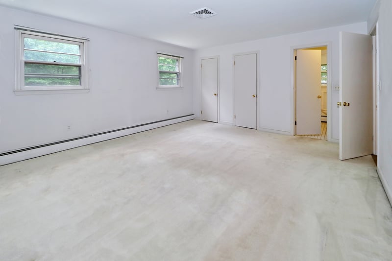 Alternate view of primary bedroom showing two walk-in closets and full bath.