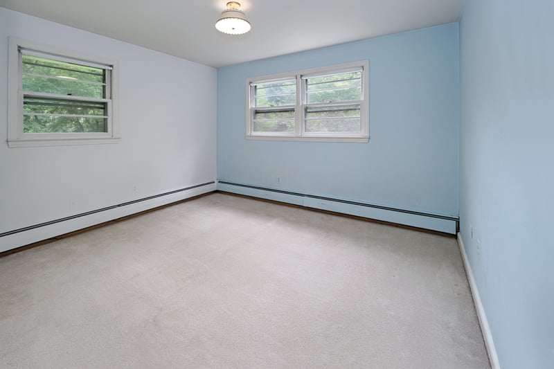 Bedroom #2 on upper level with hardwood floor and wall-to-wall carpet. 