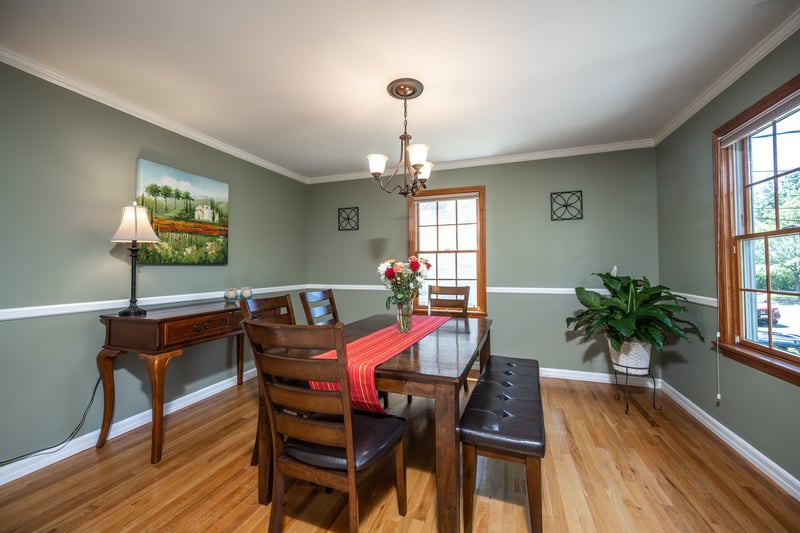 Dining area featuring a hardwood floors, lots of natural light, and crown molding. Seasonal Hudson River views, too!