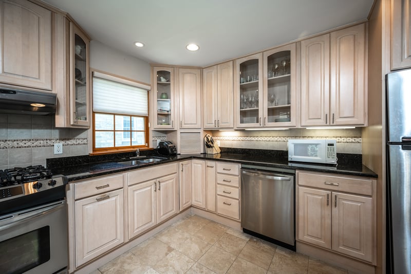 Kitchen featuring stainless steel appliances, glass insert cabinets, and recessed lighting