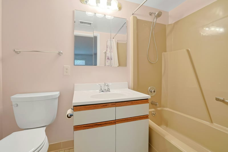 Full bath featuring vanity and shower / bath combo...