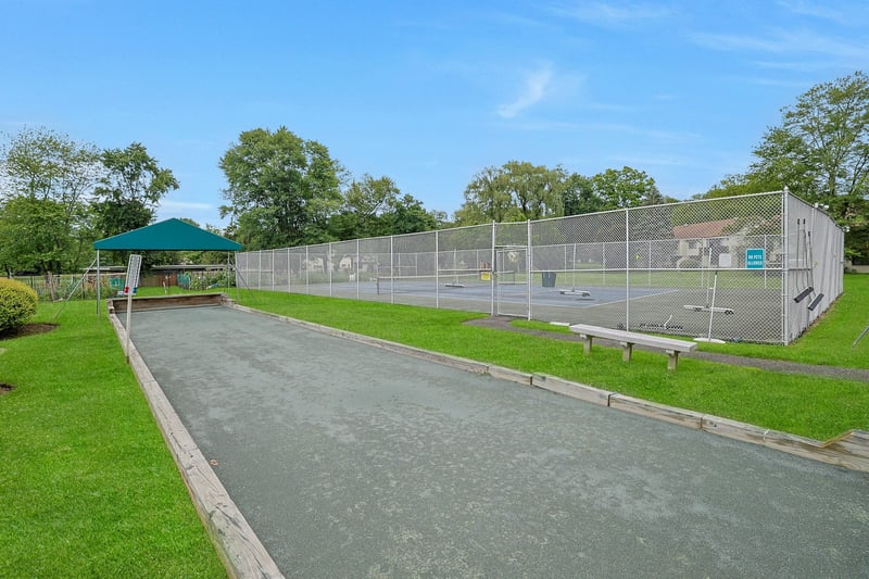 View of home's community with a tennis court...