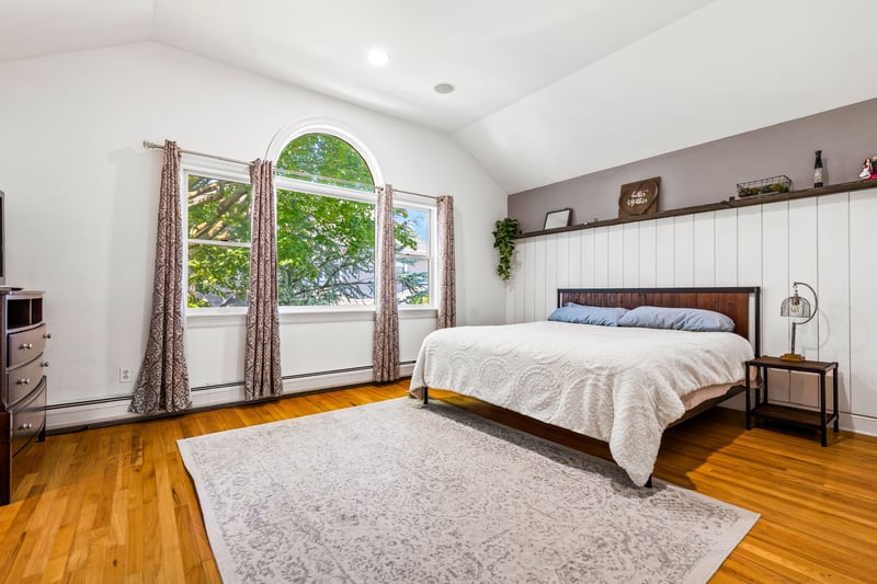 Primary bedroom with vaulted celings