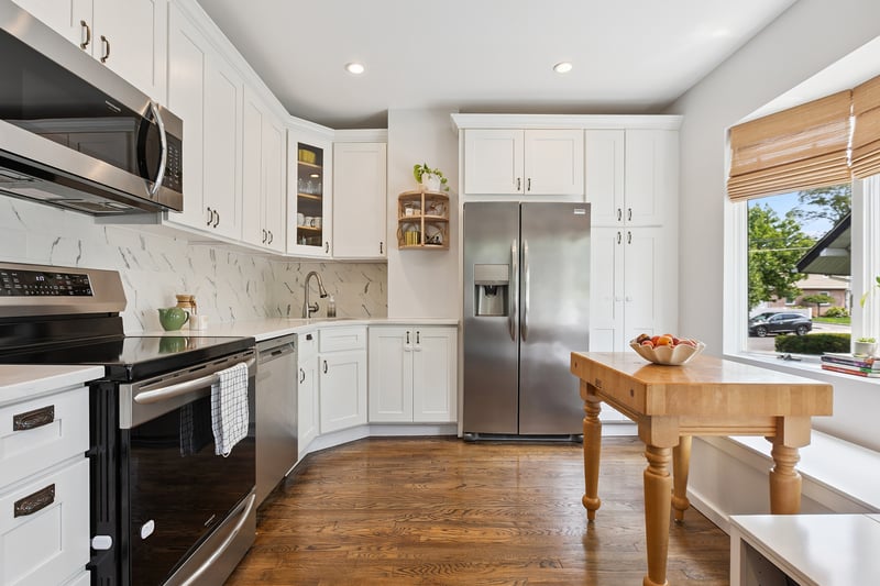 Kitchen featuring stainless steel appliances, recessed lighting, white cabinets, a wall unit AC, and tasteful backsplash...