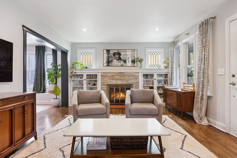 Living area featuring a fireplace, wood finished floors, and recessed lighting...