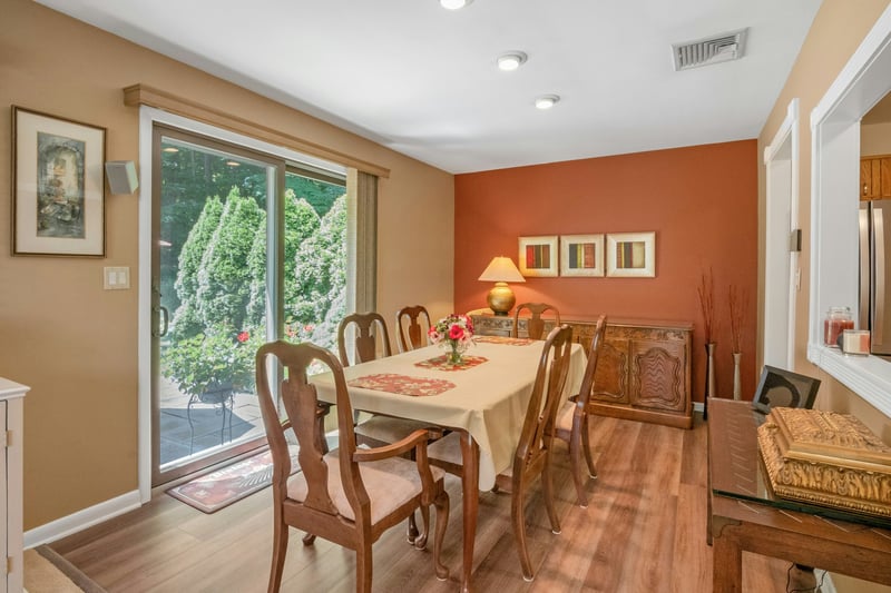 Dining room with hardwood floors and access to the private patio