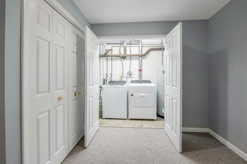Laundry area featuring washer and clothes dryer, and updated water heater