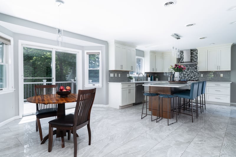 Kitchen featuring tasteful backsplash, healthy amount of natural light, and a breakfast bar area