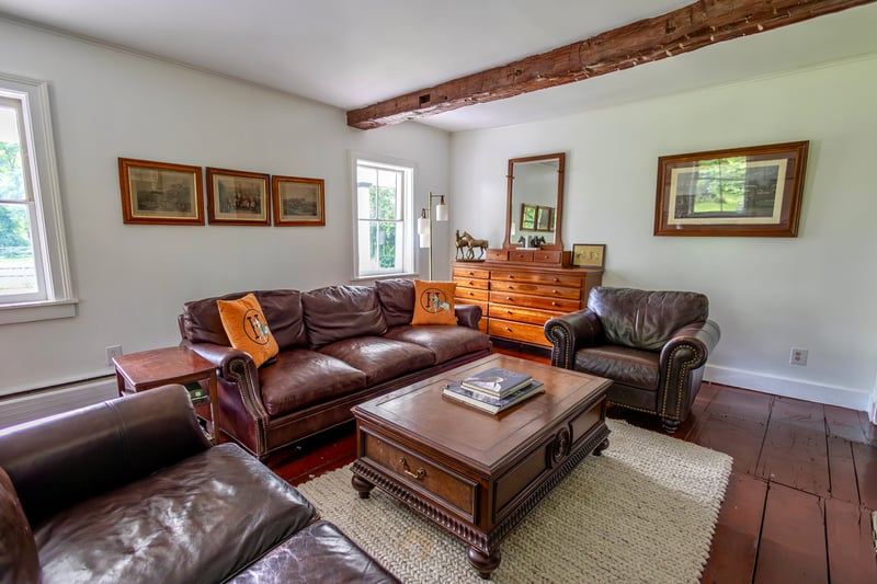 Living area with wood-type flooring and beamed ceiling