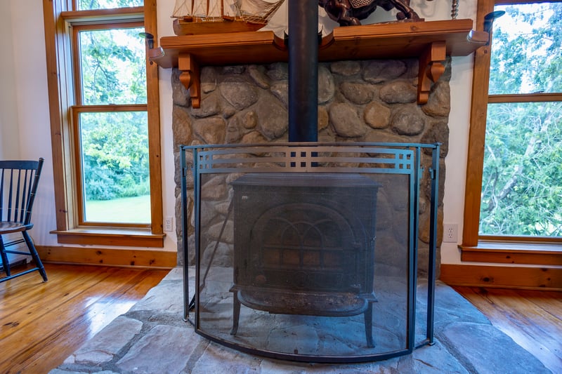Detailed view of wood finished floors and a fireplace