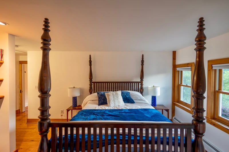 Bedroom featuring wood finished floors and baseboard heating