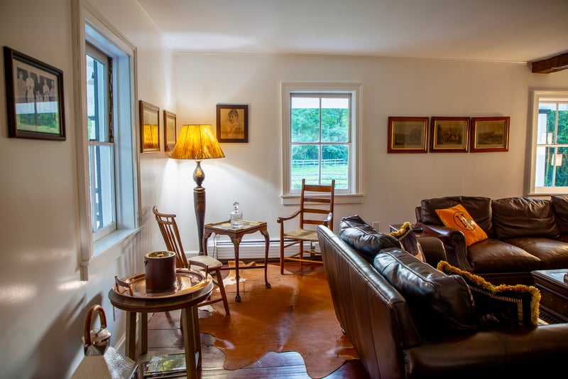 Living room featuring ornamental molding and a baseboard heating unit