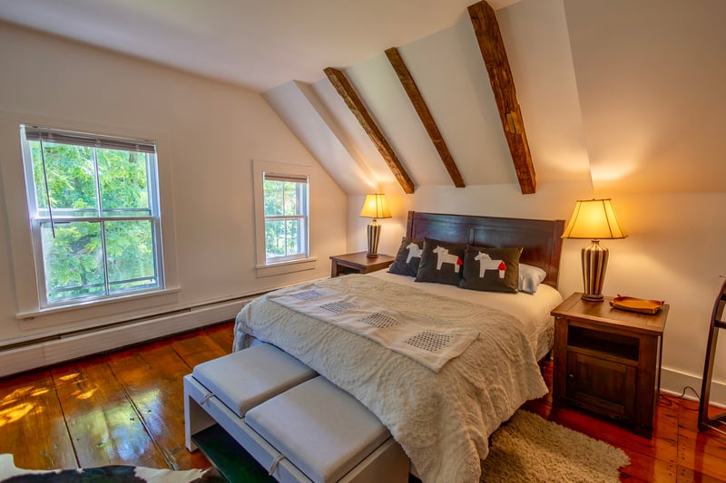 Bedroom with hardwood / wood-style floors and baseboard heating