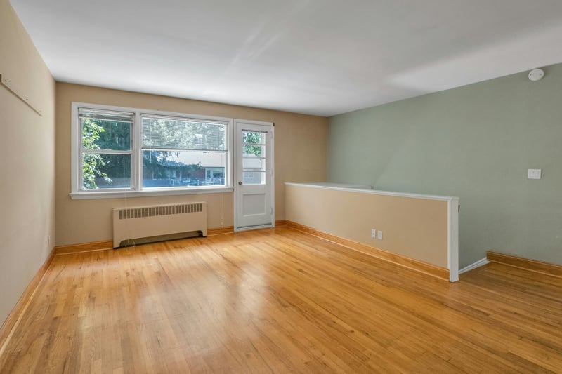 Living room with door to a private deck with views of teh Hudson River.