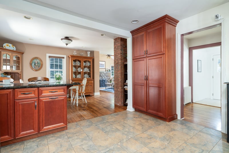 Kitchen featuring radiator, dark brown cabinets, ceiling fan, dark stone counters, and recessed lighting