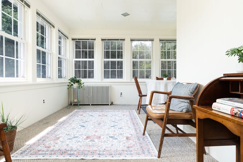 Sunroom with radiator heating unit and carpet flooring