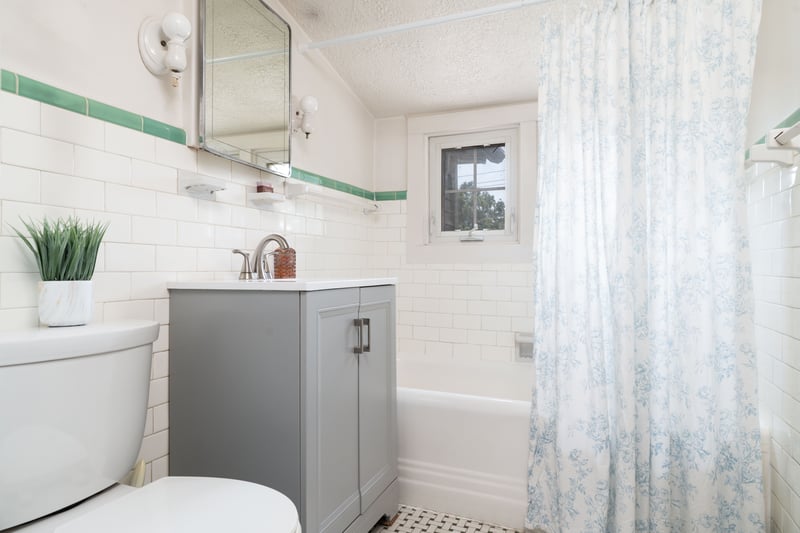 Bathroom featuring tile walls, vanity, and shower / tub combo with curtain