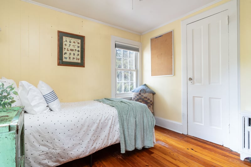 Bedroom featuring ornamental molding, hardwood / wood-style floors, and radiator heating unit