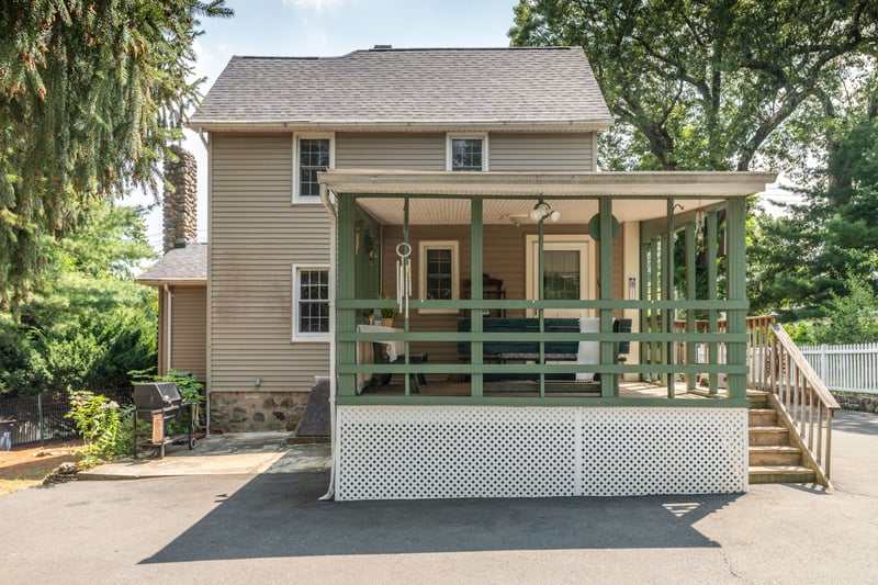 Back of house featuring a shingled roof