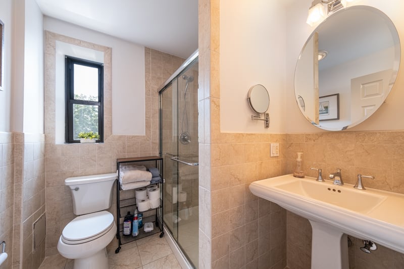 2nd Full bath featuring tile walls, a wainscoted wall, a shower stall, and tile patterned floors