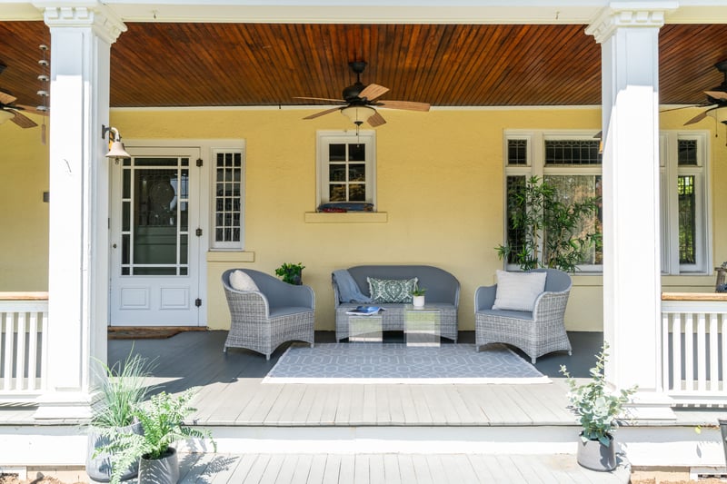 Wooden porch featuring a ceiling fan and outdoor lounge area